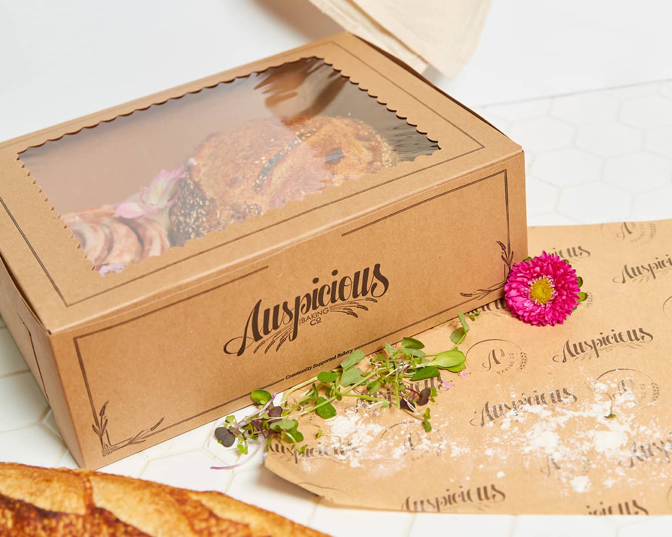 Custom box design & deli paper created for Auspicious Baking Co by Olive Ridley Studios