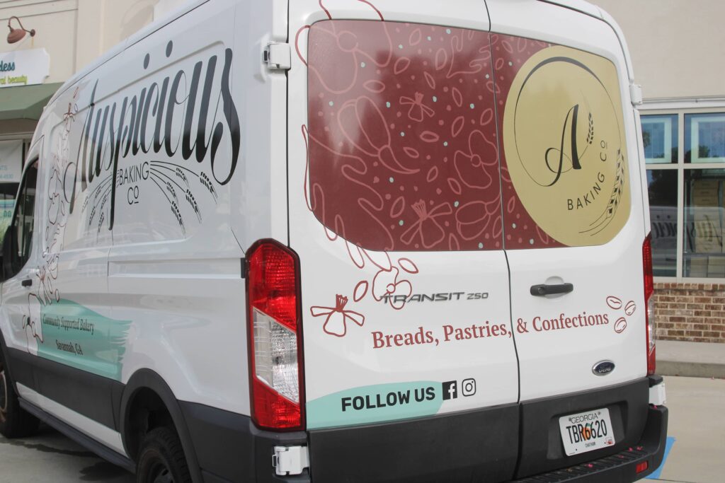 Custom van wrap (partial) created for Auspicious Baking Co by Olive Ridley Studios - close up of the back window perf