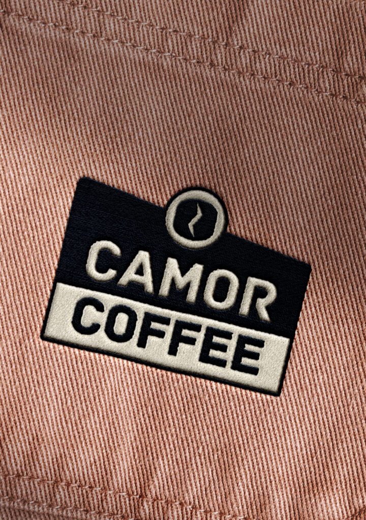 Primary logo for Camor Coffee designed by Olive Ridley Studios: Shown mocked up as an embroidered design on the pocket of a shirt