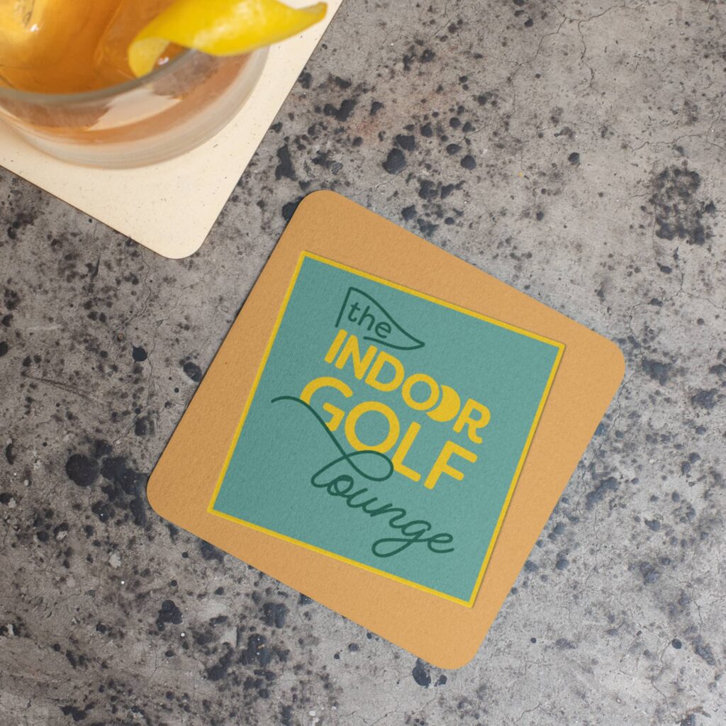 Logo design (shown on a printed coaster) created for The Indoor Golf Lounge by Olive Ridley Studios