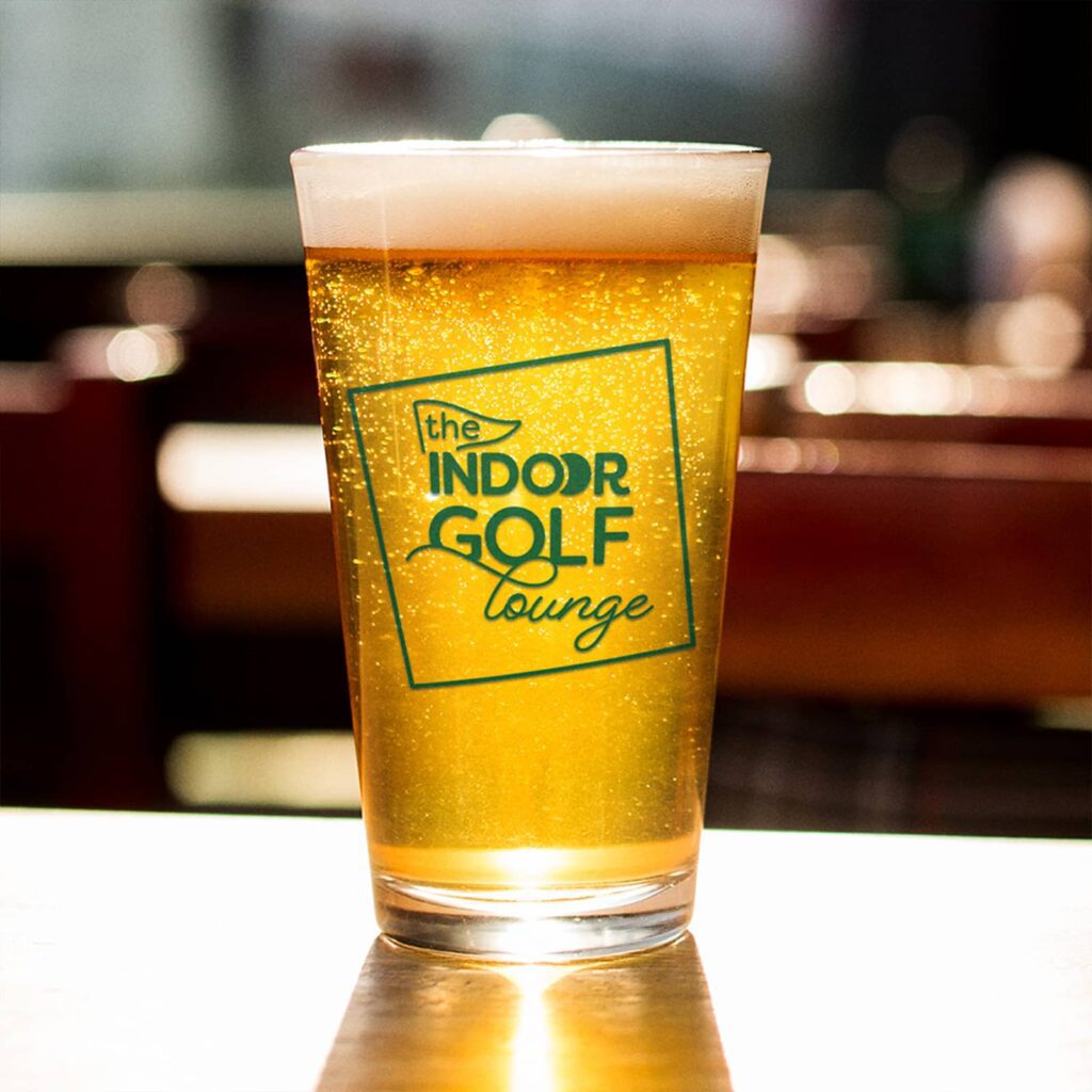 Logo design (shown as a one-color print on a glass of beer) created for The Indoor Golf Lounge by Olive Ridley Studios